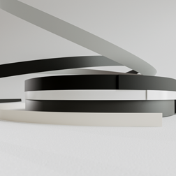 Edging rolls made of PP in black, white and grey stacked on top of each other.