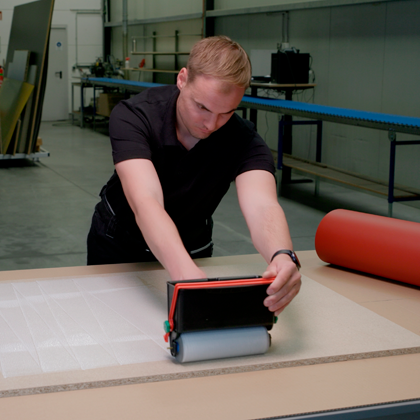 Auftragung von Klebstoff durch Moosgummiwalze